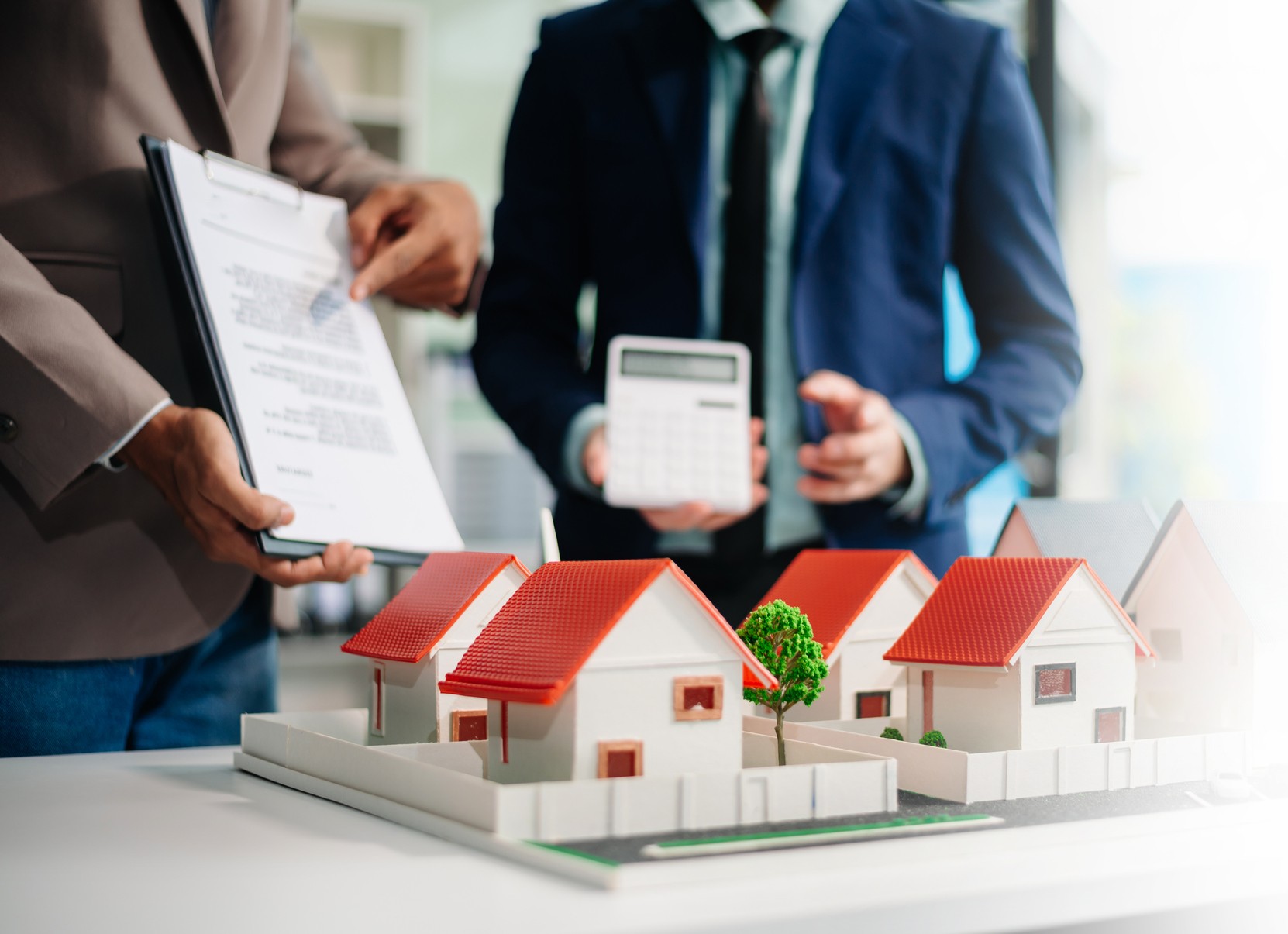 Real estate professionals reviewing investment financing options with DSCR loans for rental properties.