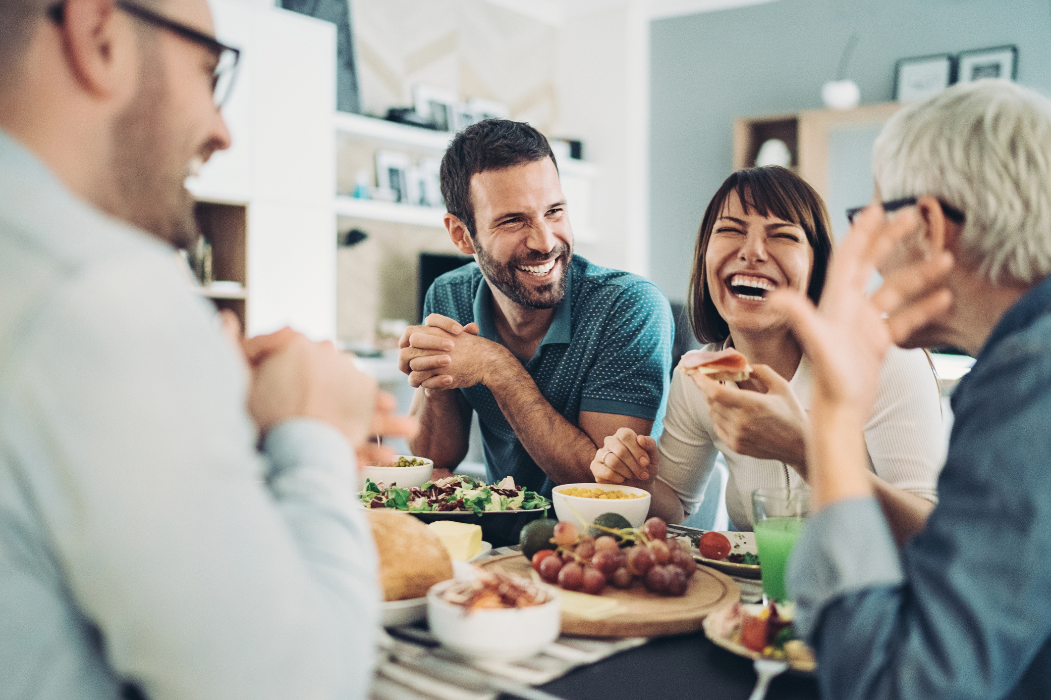 A happy family enjoying a meal together in their home, representing the joy of homeownership.