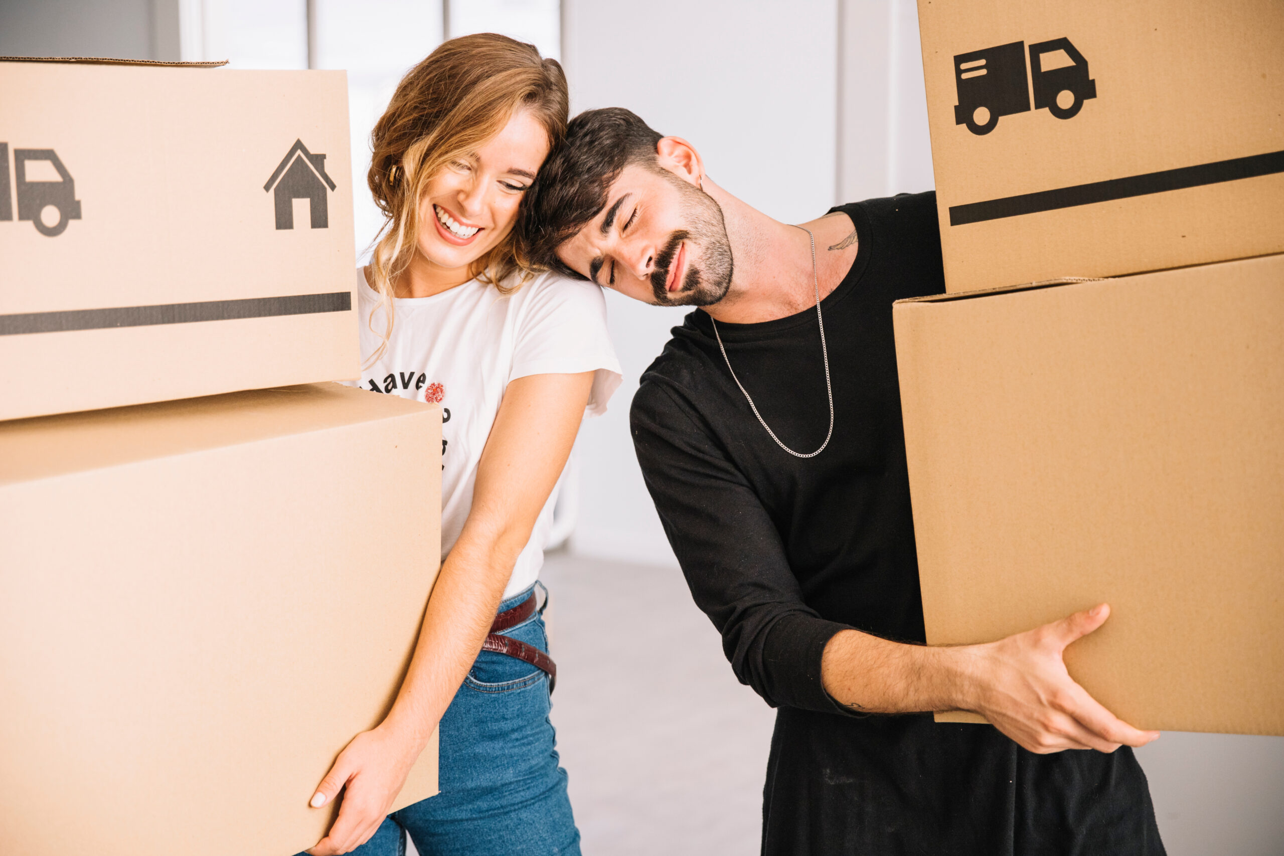 A couple excitedly moving into their new home, representing the ease of homeownership with affordable mortgage options.