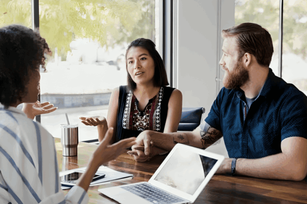 Homebuyers meeting with a mortgage lender to discuss buying a home and financing options