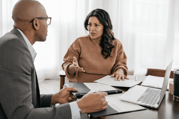 Homeowners reviewing refinance options with a mortgage advisor during a home loan consultation